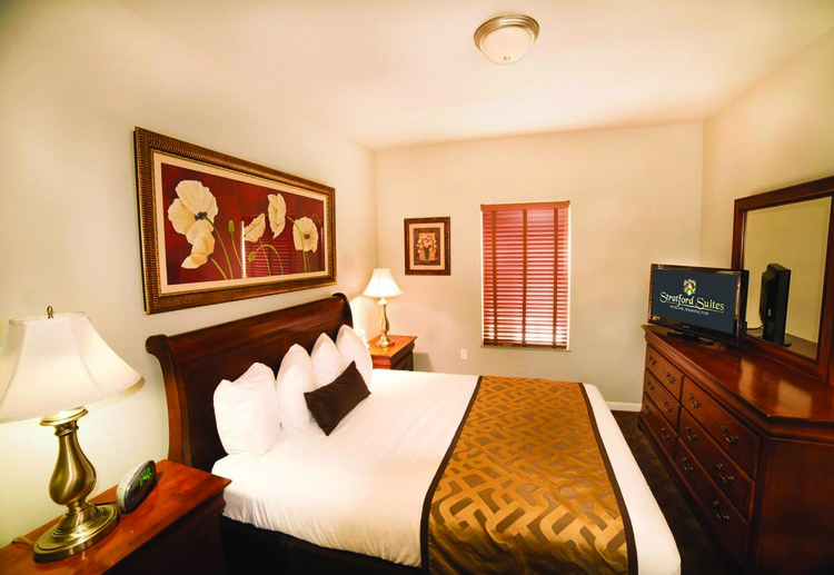 Bedroom with TV displaying Stratford Suites